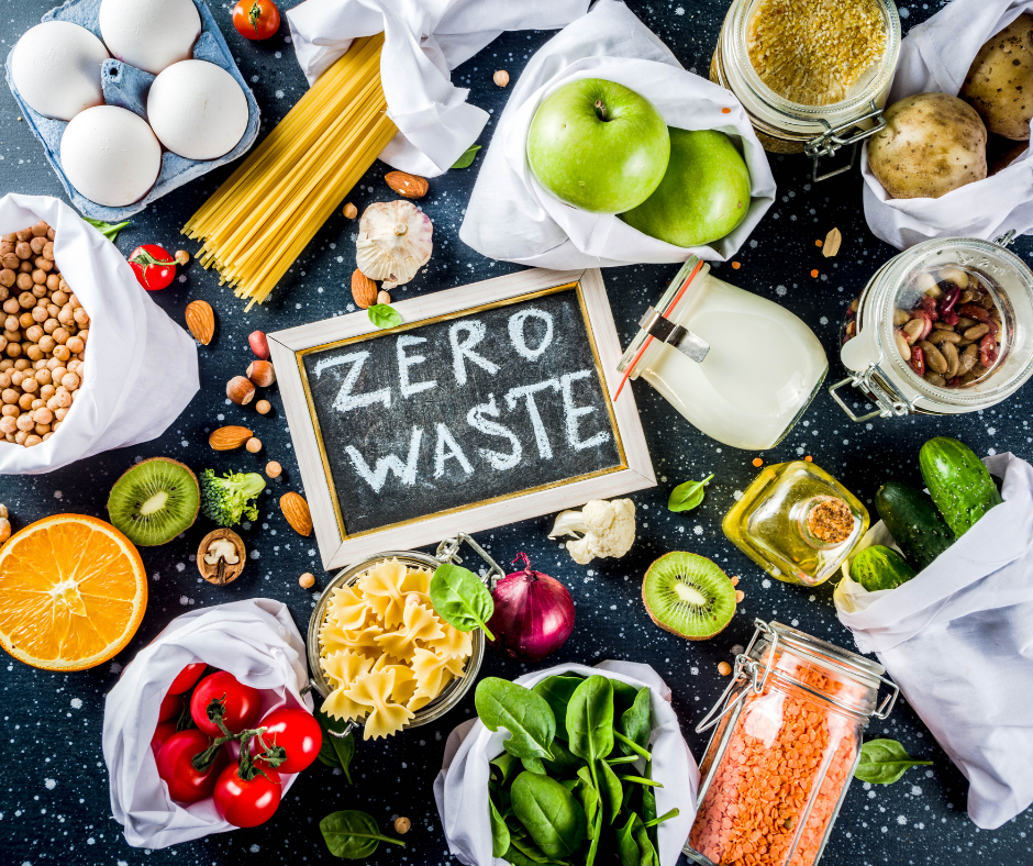 Food without plastic packaging including tomatoes, apples, kiwi, basil, spaghetti and a jar of lentils with a chalkboard in the middle with zero waste written on it Food without plastic packaging including tomatoes, apples, kiwi, basil, spaghetti and a jar of lentils with a chalkboard in the middle with zero waste written on it