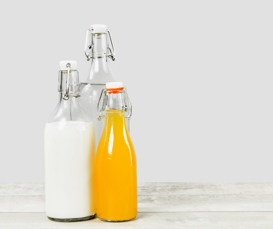 Milk, orange juice and water in glass refillable bottles Milk, orange juice and water in glass refillable bottles