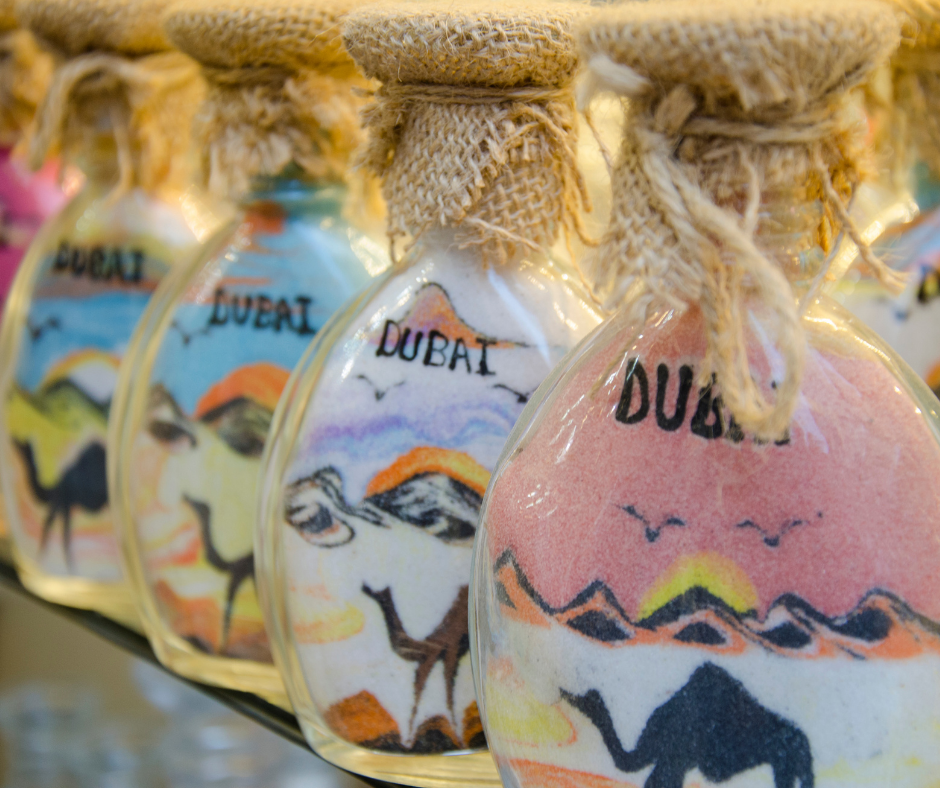 4 glass bottles with sand art with a drawing of a camel and the word Dubai 4 glass bottles with sand art with a drawing of a camel and the word Dubai