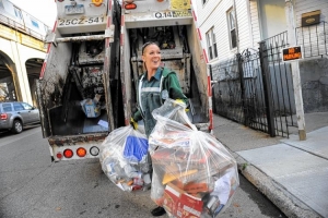 Female bin lady carrying rubbish bags (America)