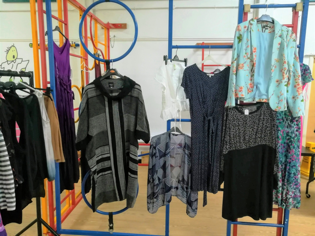 Clothes Swish Picture of clothes hanging on a climbing frame in the school hall at Marpool Primary school