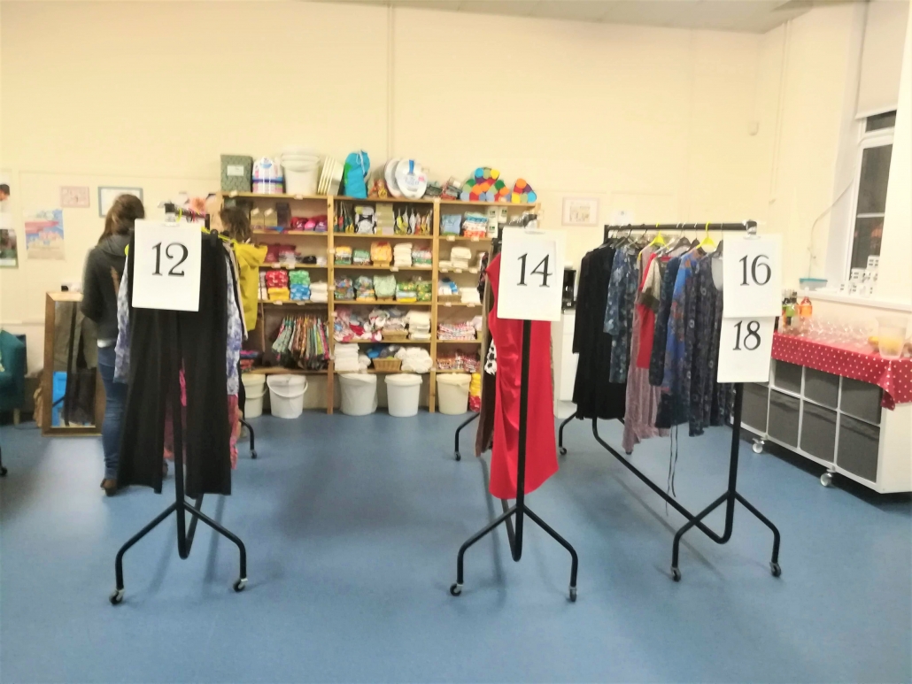Clothes swish rails Rails of clothes separated into different women's sizes at a clothes swish at Marpool Primary School
