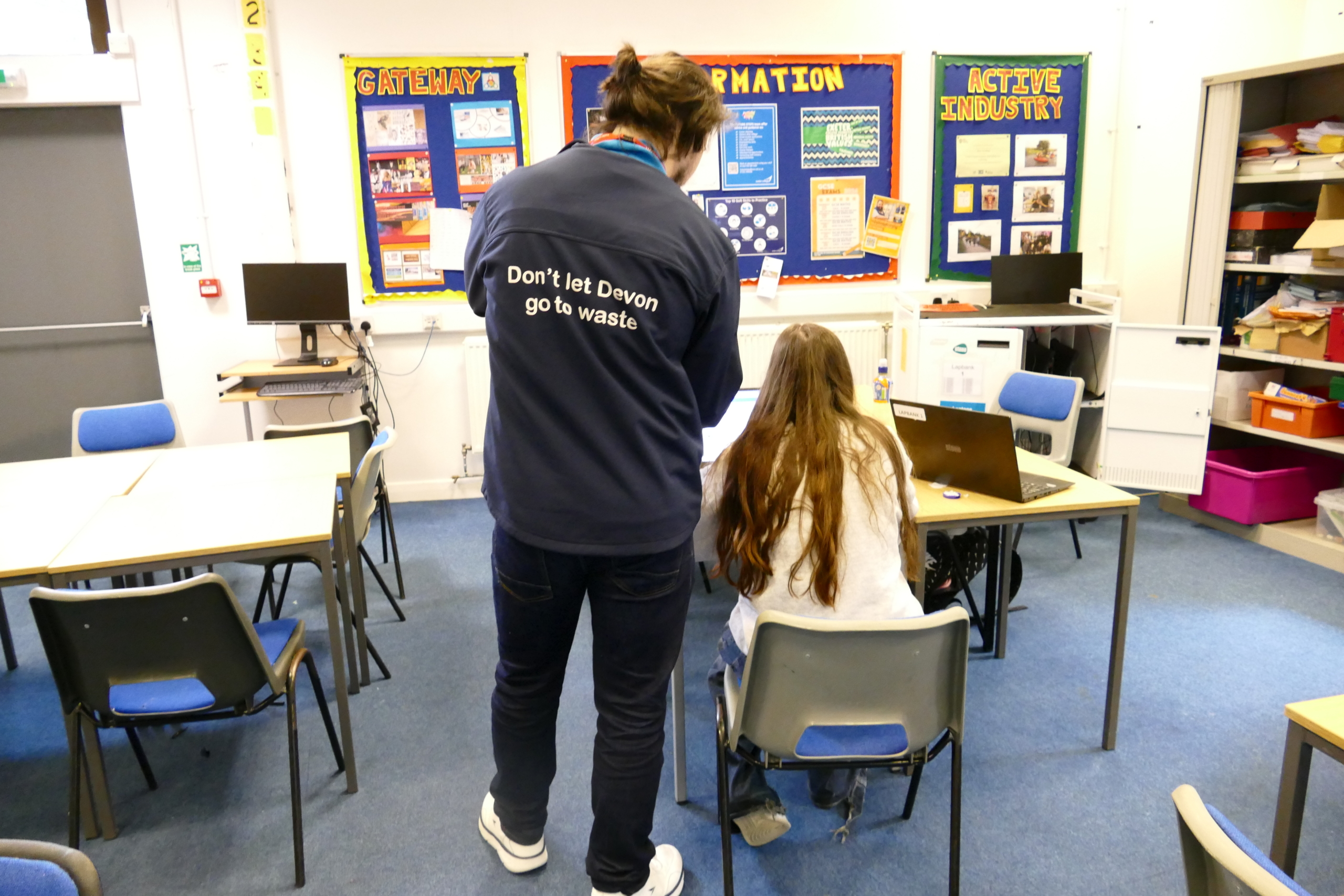One of our educators at Exeter College Picture shows an educator in a Don't Let Devon Go to Waste jacket