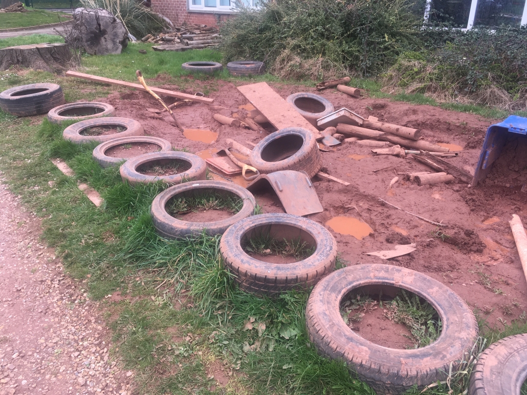 IMG_1157 Tyres, spades and other assorted items lying in mud for loose parts play at Whipton Barton Primary school