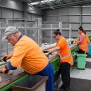 Picture of staff working to sort recycling at a Materials Recycling Facility in New Zealand