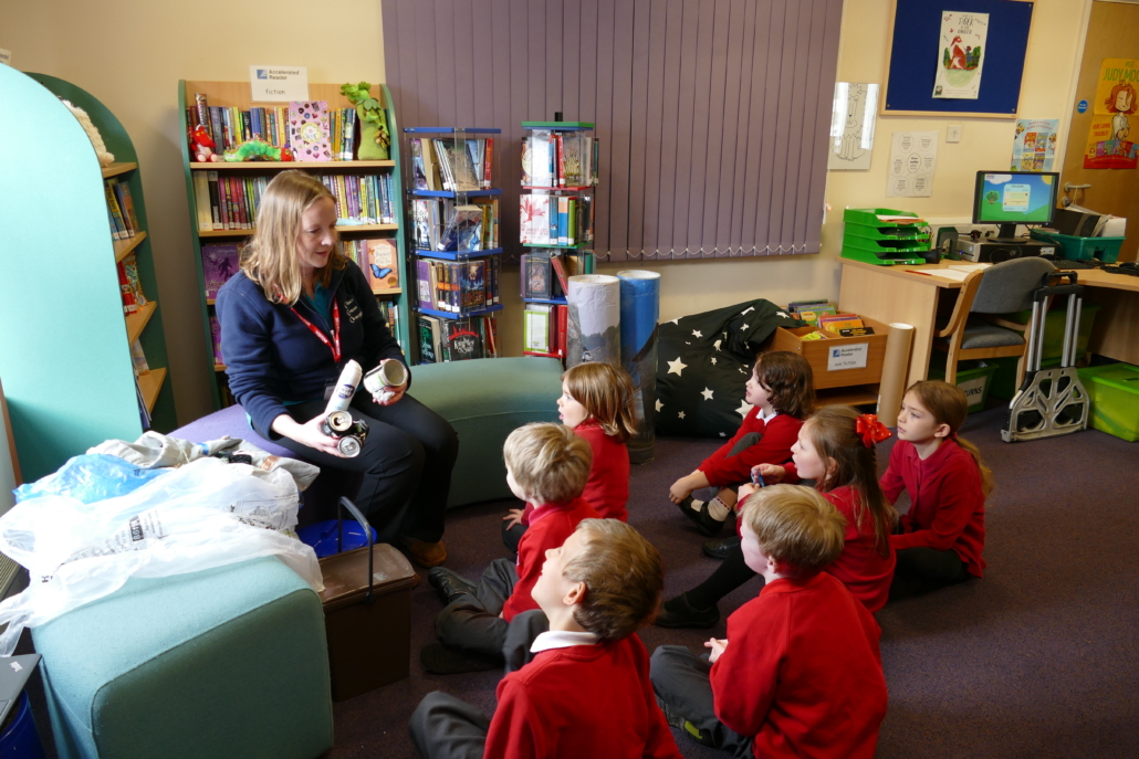 St Johns's children listening to a waste educator Children sitting around an educator in a classroom
