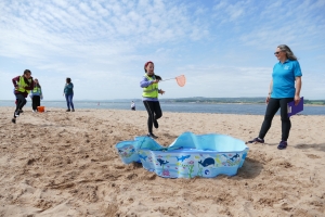 Child running towards a paddling pool with a net Child running towards a paddling pool with a net