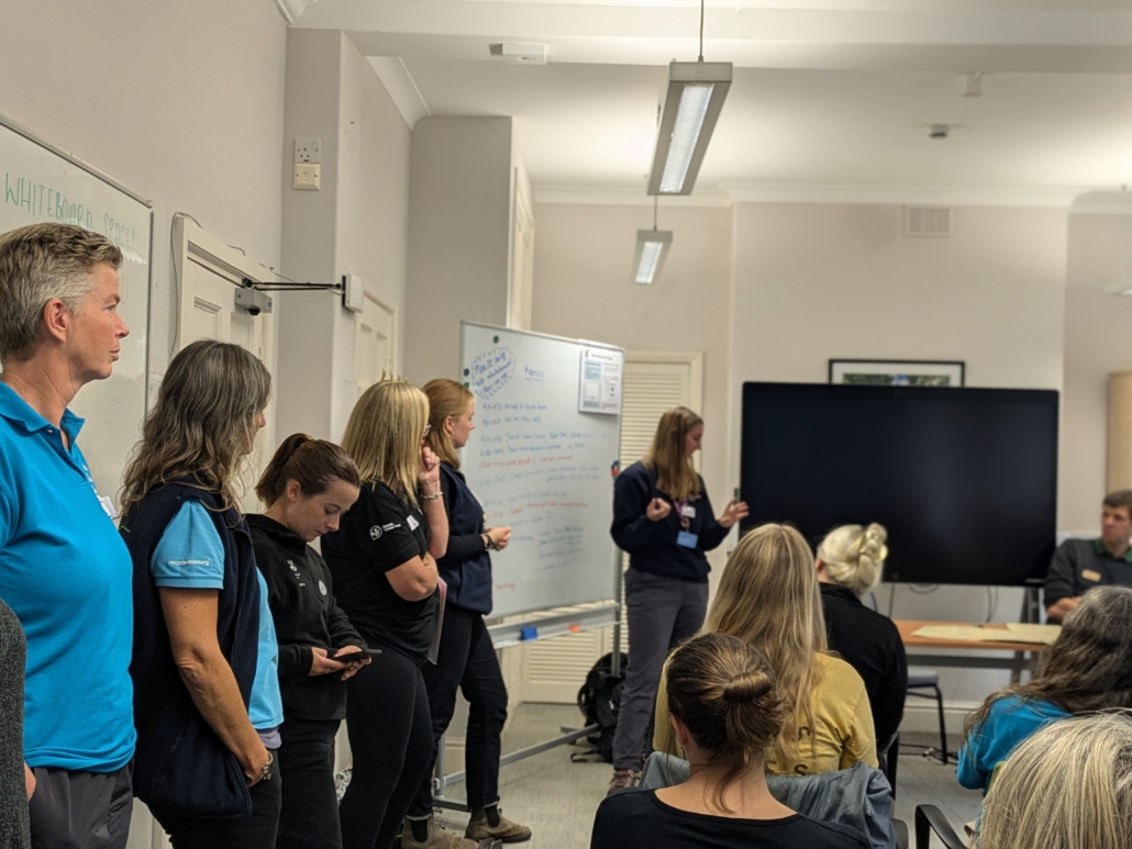 A picture of The Field Studies Council giving a presentation with many people listening
