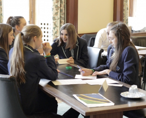 students talk through a problem in a team