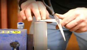 Reapir in action Scissors being sharped on a machine at a repair cafe
