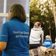 Two images combined. The left half is of a waste educator having a smiley conversation with a resident. The right photo is a lady pointing to woodland and two children listening to her