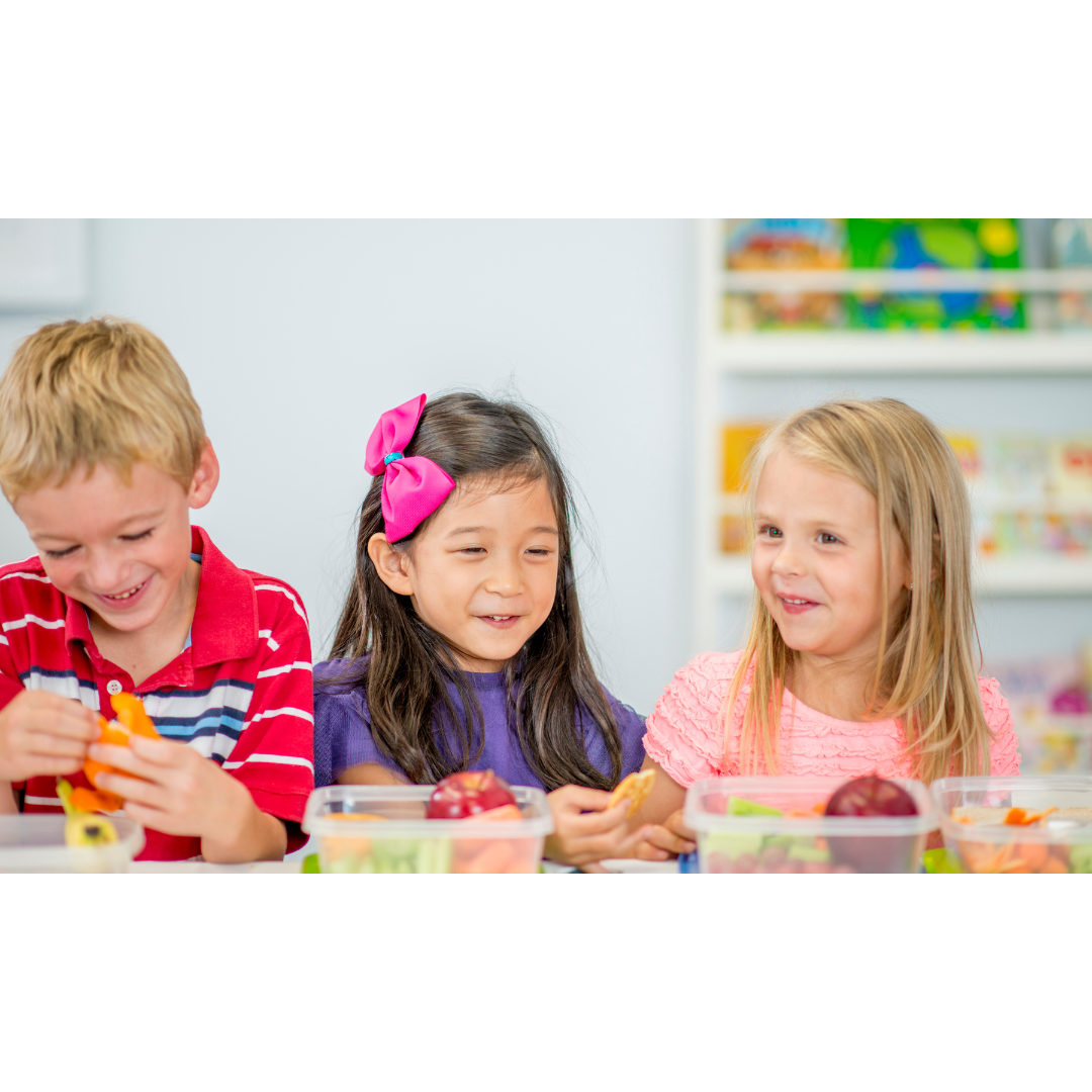 Eating lunch Three children smiling while eating packed lunch