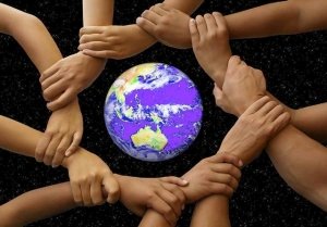 Shared Responsibility Picture of hands joined around a globe