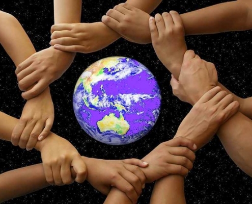Picture of hands joined around a globe
