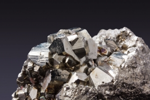 Black rock with shiny cuboid crystals of iron deposit
