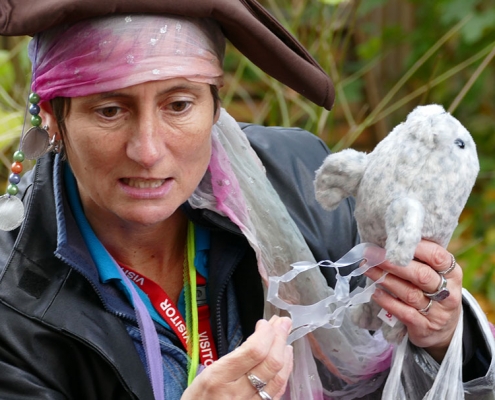 A waste educator dressed as a Pirate holding a seal toy and plastic