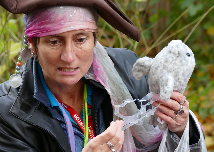 A waste educator dressed as a Pirate holding a seal toy and plastic