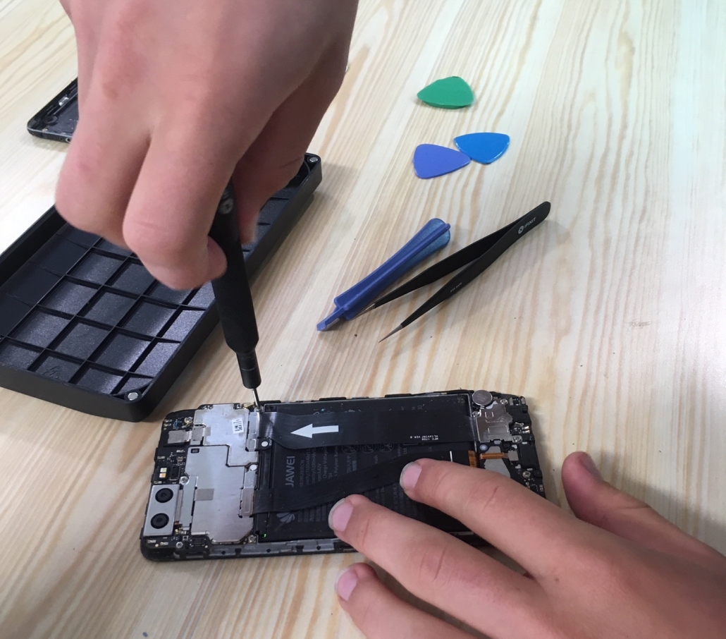 Picture of someone mending a mobile phone