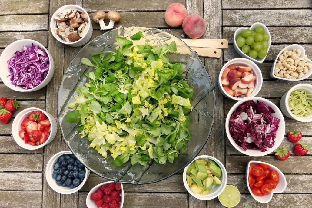 Salad Big bowl of green salad with small bowls of fruit and vegetables