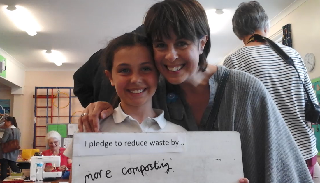 st peters 10 Child and parent holding up a pledge at St Peters Primary School Eco Fair