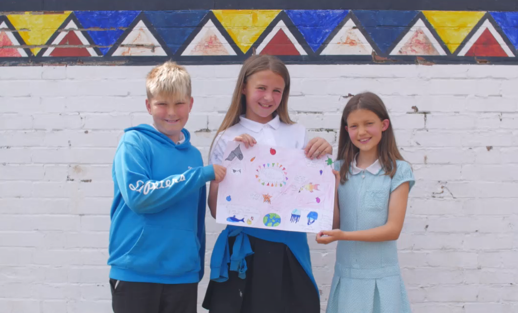 st peters 12 Smiling children holding up a poster
