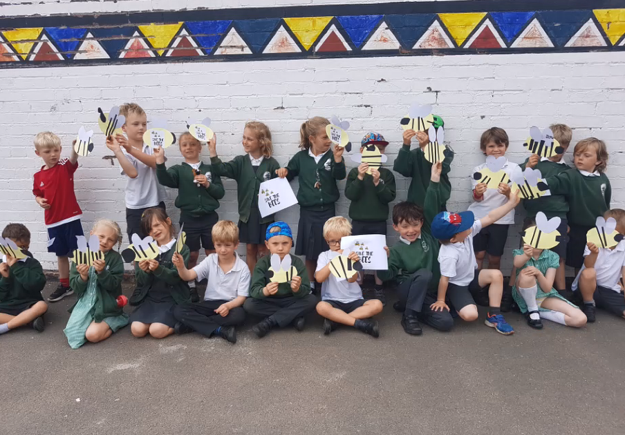 st peters 13 Group of children at St Peters Primary School in Budleigh Salterton standing and sitting showing off their bee pictures and posters