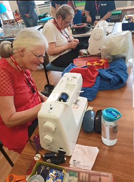 st peters Picture of two ladies sat at sewing machines demonstrating mending items at Repair Cafes