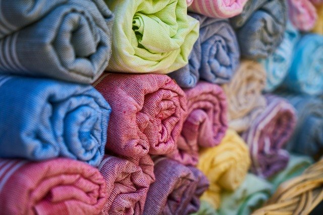 Clothes and Textiles Bright colourful rolled up textiles