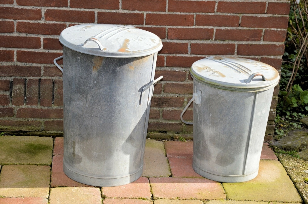 Old Dustbins Two simple metal dustbins on a patio.