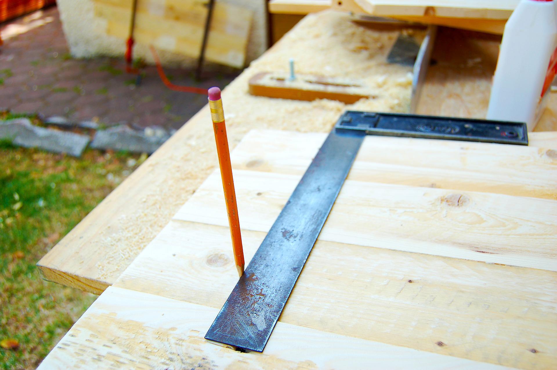 Wood work at home a set square sits on top of a piece of wood with a pencil